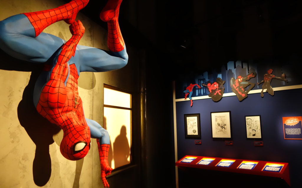 A Spider-man statue and various pieces of Spider-Man art.