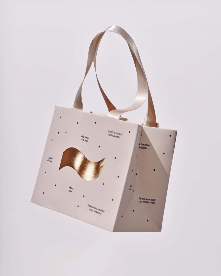 A darling little bag with a satin ribbon, foil stamping in a third colour, and die-cutting, because the outside matters too.
